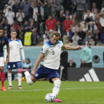 
              England's Harry Kane scores his side's first goal from the penalty spot during the World Cup quarterfinal soccer match between England and France, at the Al Bayt Stadium in Al Khor, Qatar, Saturday, Dec. 10, 2022. (AP Photo/Abbie Parr)
            
