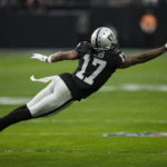 Las Vegas Raiders wide receiver Davante Adams dives in an attempt to catch a pass during the first half of an NFL football game between the New England Patriots and Las Vegas Raiders, Sunday, Dec. 18, 2022, in Las Vegas. (AP Photo/John Locher)