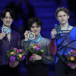 First place Japan's Shoma Uno, center, second place Japan's Sota Yamamoto, left, and third place United States' Ilia Malinin pose with their medals during the victory ceremony for the Men's Free Skating at the figure skating Grand Prix finals at the Palavela ice arena, in Turin, Italy, Saturday, Dec. 10, 2022. (AP Photo/Antonio Calanni)