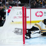 Arizona Coyotes center Nick Schmaltz (8) watches the puck in the net on his goal against Boston Bruins goaltender Jeremy Swayman during the third period of an NHL hockey game in Tempe, Ariz., Friday, Dec. 9, 2022. The Coyotes won 4-3. (AP Photo/Ross D. Franklin)