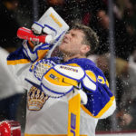 Los Angeles Kings goalie Jonathan Quick (32) sprays himself in the face before the start of the first period in an NHL hockey game against the Arizona Coyotes, Friday, Dec. 23, 2022, in Tempe, Ariz. (AP Photo/Darryl Webb)