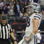 Kansas State quarterback Will Howard (18) celebrates his touchdown in the first half of the Big 12 Conference championship NCAA college football game against TCU, Saturday, Dec. 3, 2022, in Arlington, Texas. (AP Photo/LM Otero)