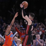 
              Miami Heat guard Tyler Herro, center, shoots the game winning shot between Oklahoma City Thunder guard Aaron Wiggins, left, and forward Jalen Williams, right, in the second half of an NBA basketball game Wednesday, Dec. 14, 2022, in Oklahoma City. (AP Photo/Sue Ogrocki)
            