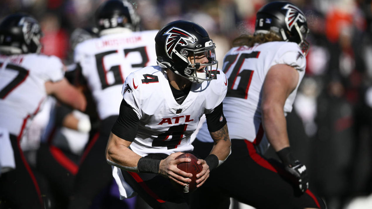 Atlanta Falcons quarterback Desmond Ridder (4) scrambles during the first half of an NFL football g...