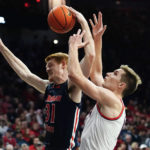 Morgan State's Ty Horner (31) battles for a rebound with Arizona's Azuolas Tubelis, right, during the second half of an NCAA college basketball game, Thursday, Dec. 22, 2022, in Tucson, Ariz. (AP Photo/Darryl Webb)