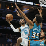 Charlotte Hornets forward Jalen McDaniels (6) shoots against Detroit Pistons forward Marvin Bagley III (35) during the first half of an NBA basketball game in Charlotte, N.C., Wednesday, Dec. 14, 2022. (AP Photo/Nell Redmond)