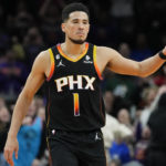 Phoenix Suns guard Devin Booker reacts to a basket during the second half of an NBA basketball game against the New Orleans Pelicans, Saturday, Dec. 17, 2022, in Phoenix. The Suns defeated the Pelicans 118-114. (AP Photo/Matt York)