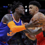 
              New York Knicks forward Julius Randle, left, is fouled by Houston Rockets forward Kenyon Martin Jr., right, on a drive to the basket during the first half of an NBA basketball game Saturday, Dec. 31, 2022, in Houston. (AP Photo/Michael Wyke)
            