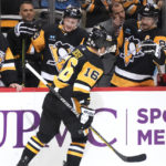 Pittsburgh Penguins' Jason Zucker (16) returns to the bench after scoring during the second period of the team's NHL hockey game against the St. Louis Blues in Pittsburgh, Saturday, Dec. 3, 2022. (AP Photo/Gene J. Puskar)