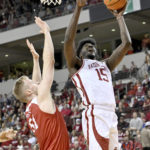 Arkansas forward Makhi Mitchell (15) shoots over Bradley forward Rienk Mast during the first half of an NCAA college basketball game, Saturday, Dec. 17, 2022, in North Little Rock, Ark. (AP Photo/Michael Woods)