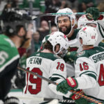 
              Minnesota Wild left wing Jordan Greenway (18) celebrates his goal with teammates Nic Petan (19) and Jared Spurgeon (46) as Dallas Stars center Joe Pavelski (16) skates past during the second period of an NHL hockey game in Dallas, Sunday, Dec. 4, 2022. (AP Photo/LM Otero)
            