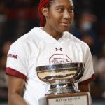 South Carolina forward Aliyah Boston holds the Honda-Broderick Cup naming her the Collegiate Woman Athlete of the Year by Jenny Gilger before an NCAA college basketball game against Charleston Southern in Columbia, S.C., Sunday, Dec. 18, 2022. (AP Photo/Nell Redmond)