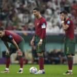 Portugal's Cristiano Ronaldo, center, stands with his teammates during the World Cup round of 16 soccer match between Portugal and Switzerland, at the Lusail Stadium in Lusail, Qatar, Tuesday, Dec. 6, 2022. (AP Photo/Alessandra Tarantino)