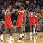 
              Houston guards Marcus Sasser (0) and Jamal Shead (1) celebrate during the second half of an NCAA college basketball game against Virginia in Charlottesville, Va., Saturday, Dec. 17, 2022. (AP Photo/Erin Edgerton)
            