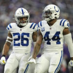 Indianapolis Colts safety Rodney McLeod (26) celebrates with teammate linebacker Zaire Franklin (44) after a fourth down stop during the first half of an NFL football game against the Minnesota Vikings, Saturday, Dec. 17, 2022, in Minneapolis. (AP Photo/Abbie Parr)