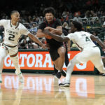 
              Miami guards Isaiah Wong (2) and Bensley Joseph (4) defend as St. Francis guard Landon Moore, center, drives between them during the second half of an NCAA college basketball game, Saturday, Dec. 17, 2022, in Coral Gables, Fla. Miami won 91-76. (AP Photo/Lynne Sladky)
            