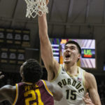 
              Purdue center Zach Edey (15) scores with a dunk while being defended by Minnesota forward Pharrel Payne (21) during the second half of an NCAA college basketball game, Sunday, Dec. 4, 2022, in West Lafayette, Ind. (AP Photo/Doug McSchooler)
            