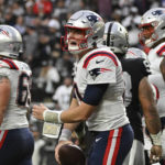 New England Patriots quarterback Mac Jones reacts after a touchdown was called back because of a penalty during the first half of an NFL football game between the New England Patriots and Las Vegas Raiders, Sunday, Dec. 18, 2022, in Las Vegas. (AP Photo/David Becker)