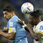 
              Ghana's Mohammed Salisu, right, challenges Uruguay's Luis Suarez during the World Cup group H soccer match between Ghana and Uruguay, at the Al Janoub Stadium in Al Wakrah, Qatar, Friday, Dec. 2, 2022. (AP Photo/Ashley Landis)
            