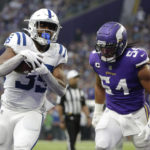 Indianapolis Colts running back Deon Jackson (35) catches a 1-yard touchdown pass ahead of Minnesota Vikings linebacker Eric Kendricks (54) during the first half of an NFL football game, Saturday, Dec. 17, 2022, in Minneapolis. (AP Photo/Andy Clayton-King)