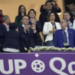 France's President Emmanuel Macron applauds at the start of the World Cup semifinal soccer match between France and Morocco at the Al Bayt Stadium in Al Khor, Qatar, Wednesday, Dec. 14, 2022. (AP Photo/Christophe Ena)