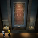 
              Visitors view an Iranian carpet at the Museum of Islamic Art in Doha, Qatar, Tuesday, Nov. 22, 2022. (AP Photo/Christophe Ena)
            