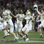 
              Oregon players celebrate after defeating North Carolina 28-27 in the Holiday Bowl NCAA college football game Wednesday, Dec. 28, 2022, in San Diego. (AP Photo/Denis Poroy)
            
