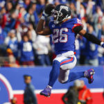 
              New York Giants' Saquon Barkley leaps into the end zone during the first half of an NFL football game against the Washington Commanders, Sunday, Dec. 4, 2022, in East Rutherford, N.J. (AP Photo/John Munson)
            