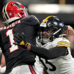 
              Atlanta Falcons quarterback Marcus Mariota (1) passes the ball as Pittsburgh Steelers linebacker Devin Bush (55) makes a hit during the second half of an NFL football game, Sunday, Dec. 4, 2022, in Atlanta. (AP Photo/Brynn Anderson)
            