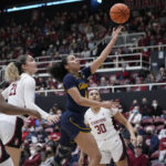 
              California guard Karisma Ortiz (4) shoots next to Stanford guard Brooke Demetre (21) during the first half of an NCAA college basketball game in Stanford, Calif., Friday, Dec. 23, 2022. (AP Photo/Godofredo A. Vásquez)
            