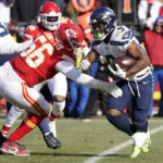 
              Seattle Seahawks running back Kenneth Walker III (9) runs with the ball as Kansas City Chiefs defensive end George Karlaftis (56) defends during the first half of an NFL football game Saturday, Dec. 24, 2022, in Kansas City, Mo. (AP Photo/Ed Zurga)
            