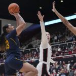 
              California forward Peanut Tuitele, left, shoots over Stanford center Lauren Betts (51) during the first half of an NCAA college basketball game in Stanford, Calif., Friday, Dec. 23, 2022. (AP Photo/Godofredo A. Vásquez)
            