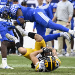 Iowa wide receiver Nico Ragaini (89) pulls in a pass as Kentucky defensive back Tyrell Ajian (6) defends in the second half of the Music City Bowl NCAA college football game Saturday, Dec. 31, 2022, in Nashville, Tenn. Iowa won 21-0. (AP Photo/Mark Zaleski)