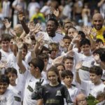 
              FILE - Brazilian soccer legend Pele, center top, and his son Edson Cholbi do Nascimento, above at right, wave with children during during the centennial anniversary celebration of the team in Santos, Brazil, April 14, 2012. Pelé, the Brazilian king of soccer who won a record three World Cups and became one of the most commanding sports figures of the last century, died in Sao Paulo on Thursday, Dec. 29, 2022. He was 82. (AP Photo/Nelson Antoine, File)
            