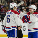 Montreal Canadiens' Chris Wideman (6) goes to celebrate Cole Caufield's (22) goal in the second period during an NHL hockey game against the Arizona Coyotes, Monday, Dec. 19, 2022, in Tempe, Ariz. (AP Photo/Darryl Webb)