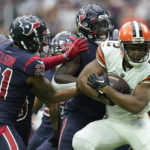 
              Cleveland Browns wide receiver Amari Cooper (2) is tackled by Houston Texans cornerback Steven Nelson (21) and Christian Harris (48) during the first half of an NFL football game between the Cleveland Browns and Houston Texans in Houston, Sunday, Dec. 4, 2022,. (AP Photo/Eric Gay)
            
