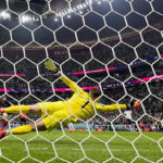 
              England's goalkeeper Jordan Pickford is beaten by a shot from France's Aurelien Tchouameni for the opening goal during the World Cup quarterfinal soccer match between England and France, at the Al Bayt Stadium in Al Khor, Qatar, Saturday, Dec. 10, 2022. (AP Photo/Abbie Parr)
            
