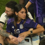 Argentina's Lionel Messi sits with his wife Antonela Roccuzzo after Argentina won the World Cup final soccer match against France at the Lusail Stadium in Lusail, Qatar, Sunday, Dec. 18, 2022. (AP Photo/Francisco Seco)