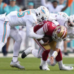 San Francisco 49ers quarterback Jimmy Garoppolo, middle, is sacked by Miami Dolphins linebacker Jerome Baker, left, and linebacker Jaelan Phillips (15) during the first half of an NFL football game in Santa Clara, Calif., Sunday, Dec. 4, 2022. (AP Photo/Godofredo A. Vásquez)