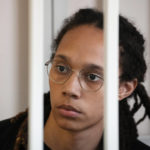 FILE - WNBA star and two-time Olympic gold medalist Brittney Griner sits in a cage at a court room prior to a hearing, in Khimki just outside Moscow, Russia, Wednesday, July 27, 2022. Now that she's back in the U.S., Griner plans to be out of the public spotlight for awhile spending time with her wife. She hasn't said if she'll ever play basketball again. (AP Photo/Alexander Zemlianichenko, Pool, File)