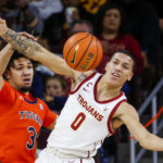 
              Southern California guard Kobe Johnson, left, and Auburn guard Tre Donaldson fight for the ball during the first half of an NCAA college basketball game, Sunday, Dec. 18, 2022, in Los Angeles. (AP Photo/Ringo H.W. Chiu)
            