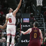 
              Chicago Bulls guard Zach LaVine, left, shoots as Cleveland Cavaliers forward Kevin Love looks on during the first half of an NBA basketball game in Chicago, Saturday, Dec. 31, 2022. (AP Photo/Nam Y. Huh)
            
