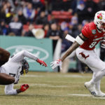
              Louisville's Jaelin Carter sheds Cincinnati defender Ethan Wright as he runs with the ball during the second quarter of the Fenway Bowl NCAA college football game at Fenway Park Saturday, Dec. 17, 2022, in Boston. (AP Photo/Winslow Townson)
            