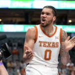Texas forward Timmy Allen (0) celebrates after scoring a basket and getting fouled during the first half of an NCAA college basketball game against Stanford Sunday, Dec. 18, 2022, in Dallas. (AP Photo/Jeffrey McWhorter)