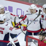 Washington Capitals' Alex Ovechkin celebrates with teammates his second goal of the game during the first period of an NHL hockey game against the Chicago Blackhawks Tuesday, Dec. 13, 2022, in Chicago. (AP Photo/Charles Rex Arbogast)