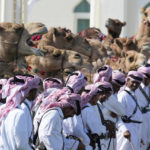 Guards pause with their camels outside the Amiri Diwan in Doha, Qatar, Tuesday, Nov. 29, 2022. (AP Photo/Eugene Hoshiko)
