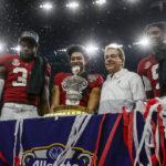 Alabama linebacker Will Anderson Jr., left, quarterback Bryce Young, center left, head coach Nick Saban, center right, and defensive back Jordan Battle, right, stand with the trophy as they celebrate after the Sugar Bowl NCAA college football game against Kansas State, Saturday, Dec. 31, 2022, in New Orleans. (AP Photo/Butch Dill)