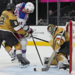 
              Vegas Golden Knights goaltender Logan Thompson (36) stops a shot attempt by New York Rangers right wing Julien Gauthier (12) during the first period of an NHL hockey game Wednesday, Dec. 7, 2022, in Las Vegas. (AP Photo/John Locher)
            