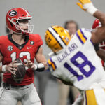 Georgia quarterback Stetson Bennett (13) sets back to pass in the first half of the Southeastern Conference championship NCAA college football game against LSU, Saturday, Dec. 3, 2022, in Atlanta. (AP Photo/Brynn Anderson)