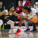 
              Lehigh's Jalin Sinclair (55) reaches in on Wisconsin's Kamari McGee (4) during the first half of an NCAA college basketball game Thursday, Dec. 15, 2022, in Madison, Wis. (AP Photo/Andy Manis)
            